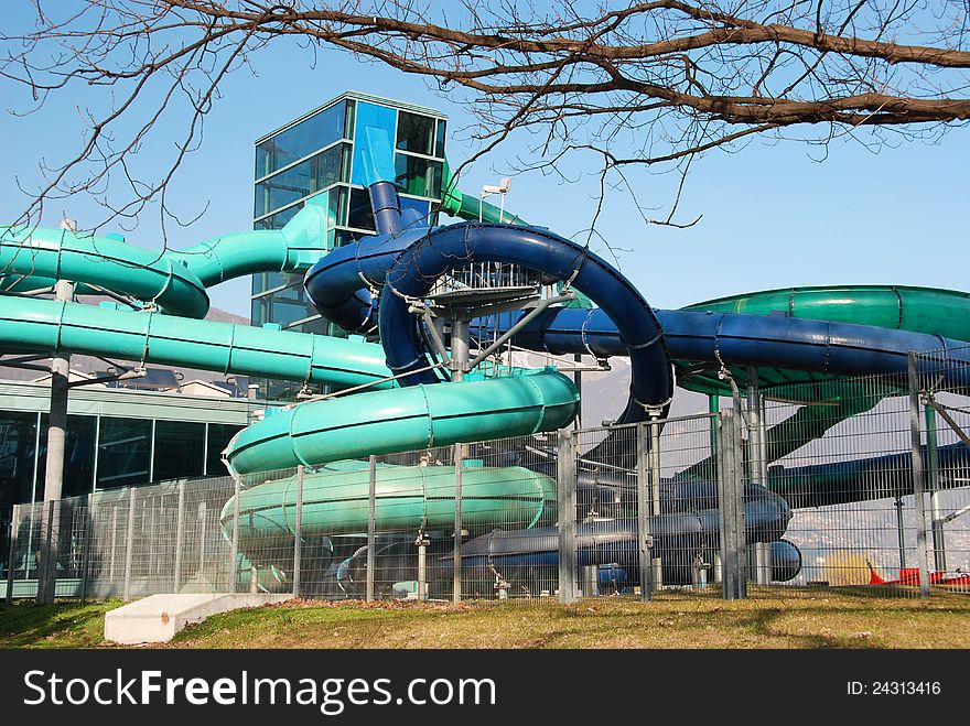 Several waterslide near swimming pool