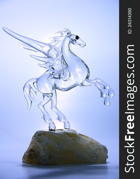The glass flying horse on precious stone. The glass flying horse on precious stone