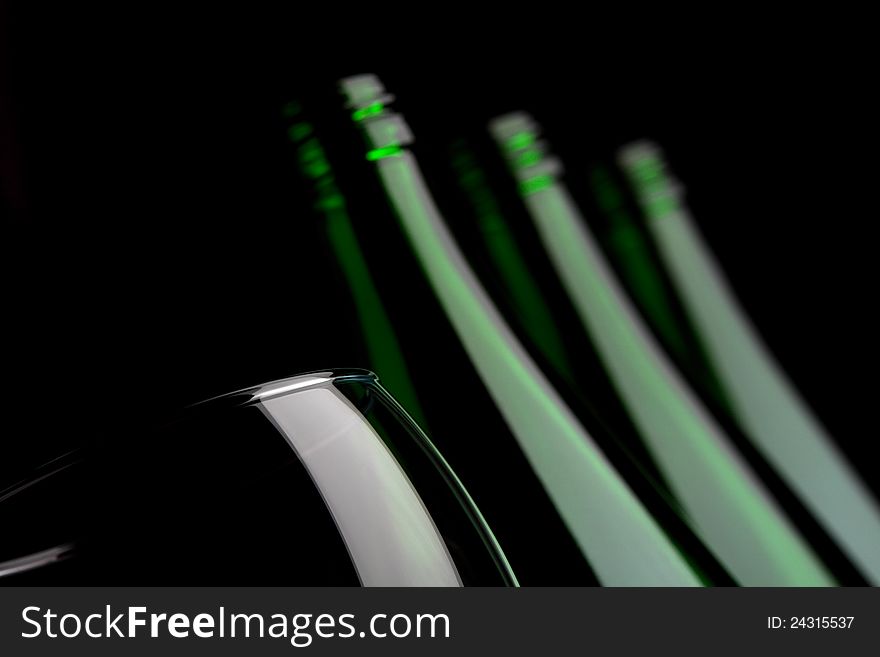 Bottles with glass on black background