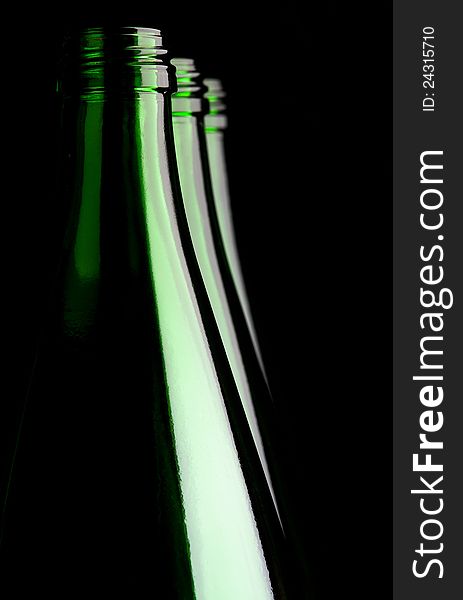 Green water bottles on a black background