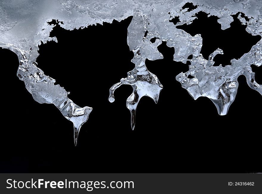 World map carving on icicles in cold light