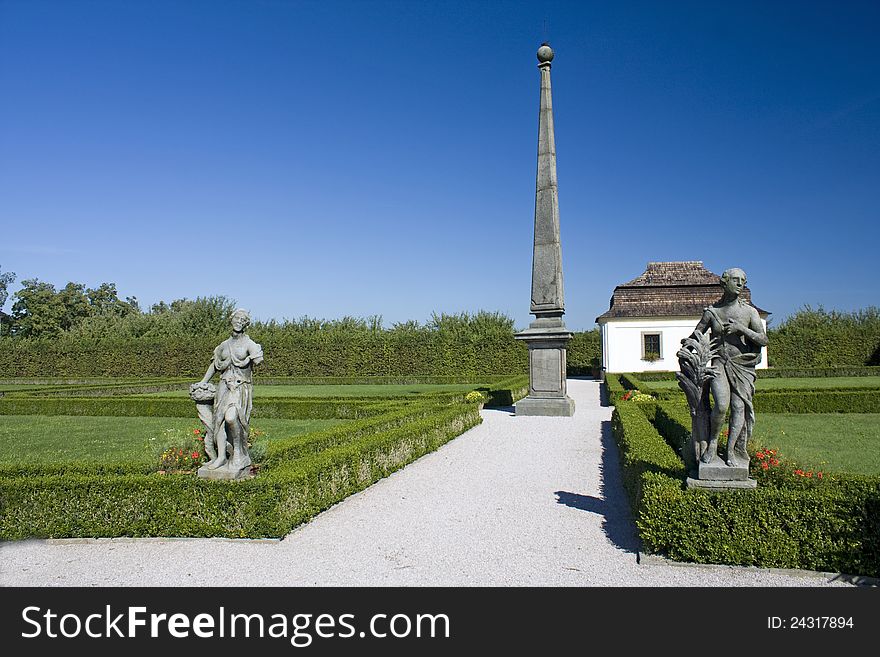 House garden with statues and obelisks, ornamental garden in the summer with a blue sky at chateau kuks. House garden with statues and obelisks, ornamental garden in the summer with a blue sky at chateau kuks