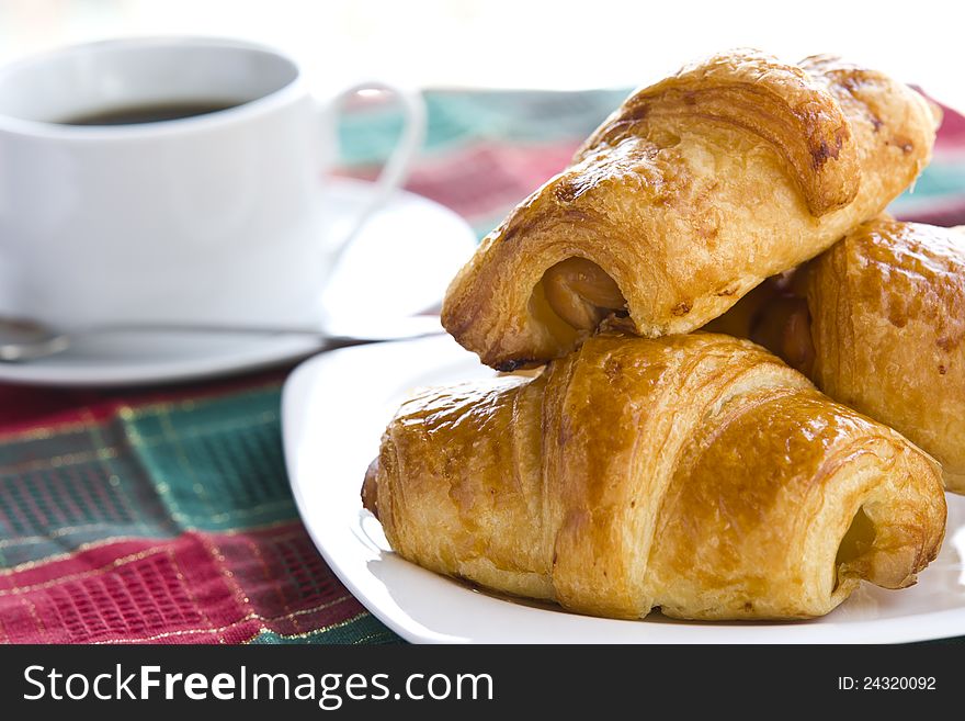 Breakfast with a cup of black coffee and croissants, Shallow DOF. Breakfast with a cup of black coffee and croissants, Shallow DOF