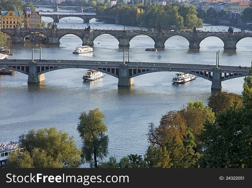 View on bridges over the river Vltava with boats in the background. View on bridges over the river Vltava with boats in the background