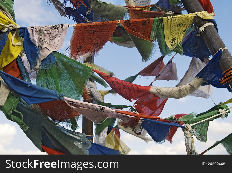 Multicoloured buddhist prayer flags against blue sky