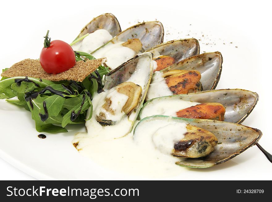 A plate of mussels and herbs in a restaurant