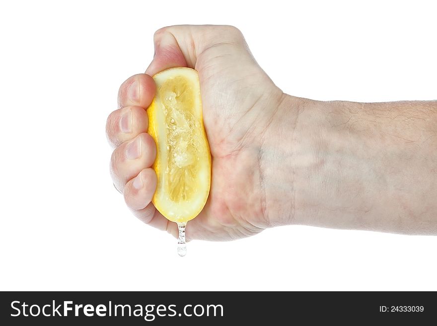 The hand squeezes a lemon. On a white background.