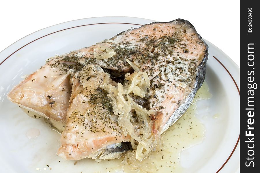 Salmon baked with onion on a plate on white. Salmon baked with onion on a plate on white