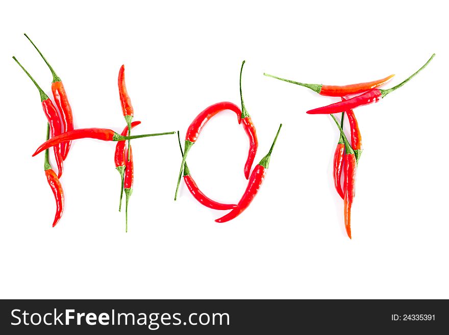 Red peppers in a word HOT on a white background