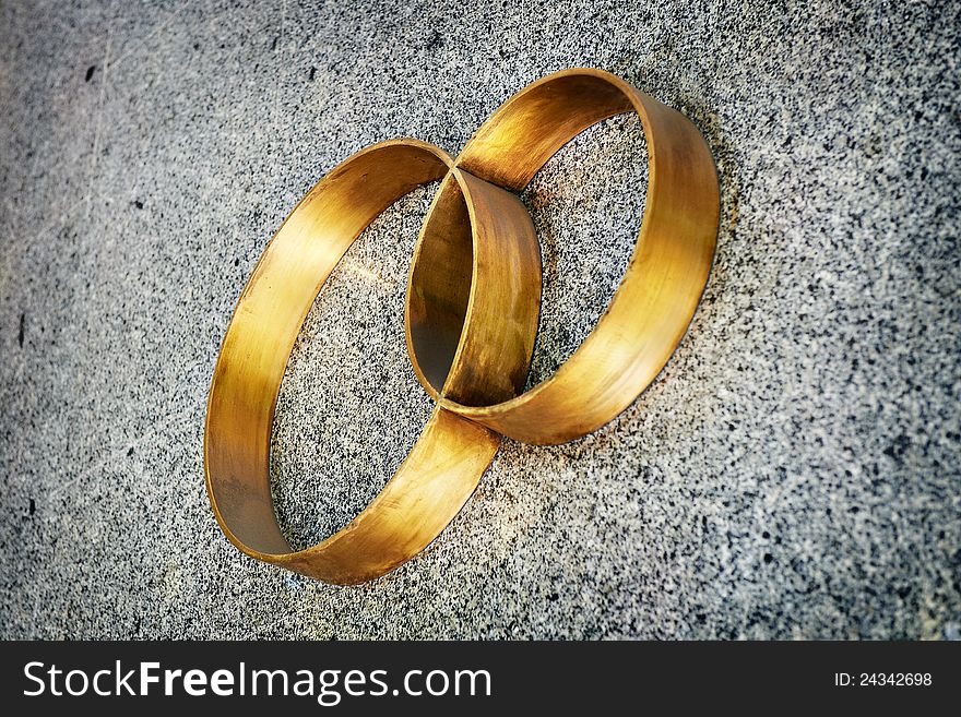 Wedding rings on gray wall