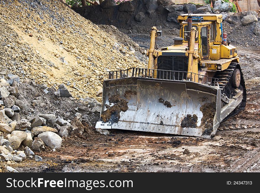 Bulldozer machine doing earthmoving work in mining