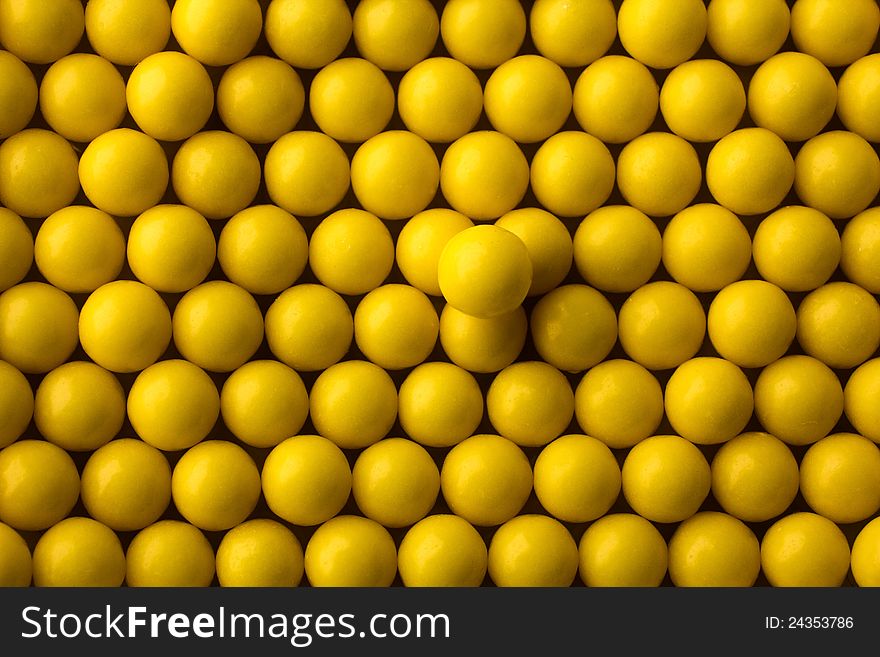 Yellow round pills background. one pill above others