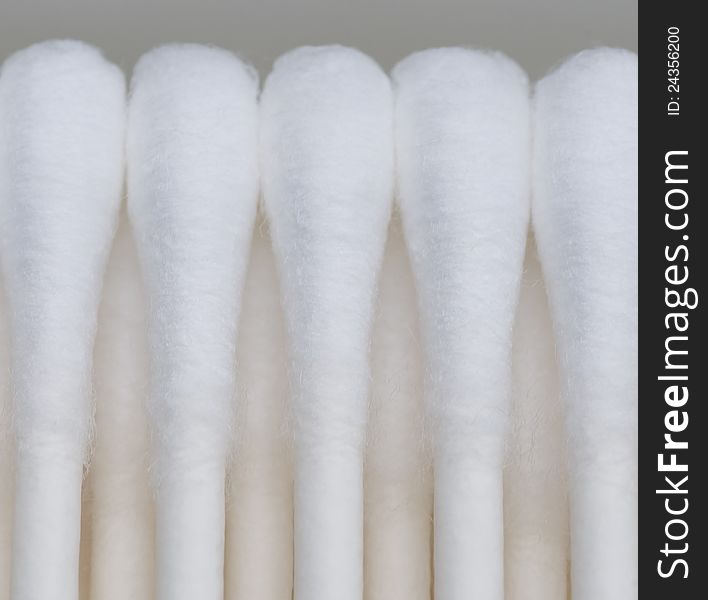 A photograph of a five cotton swabs in a row