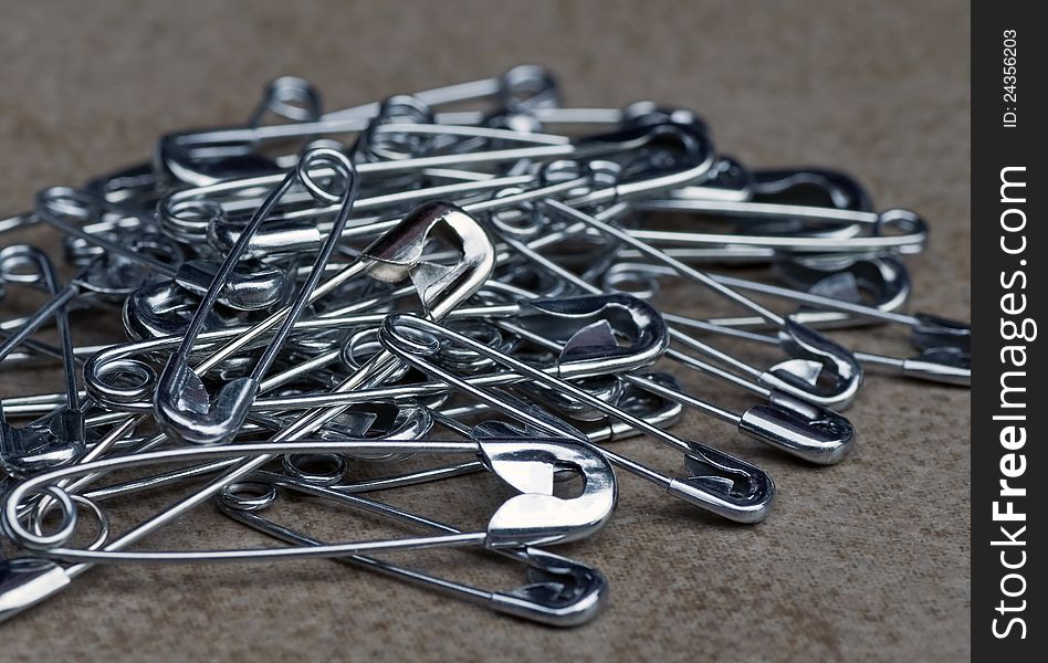 A photograph of multiple size metal safety pins