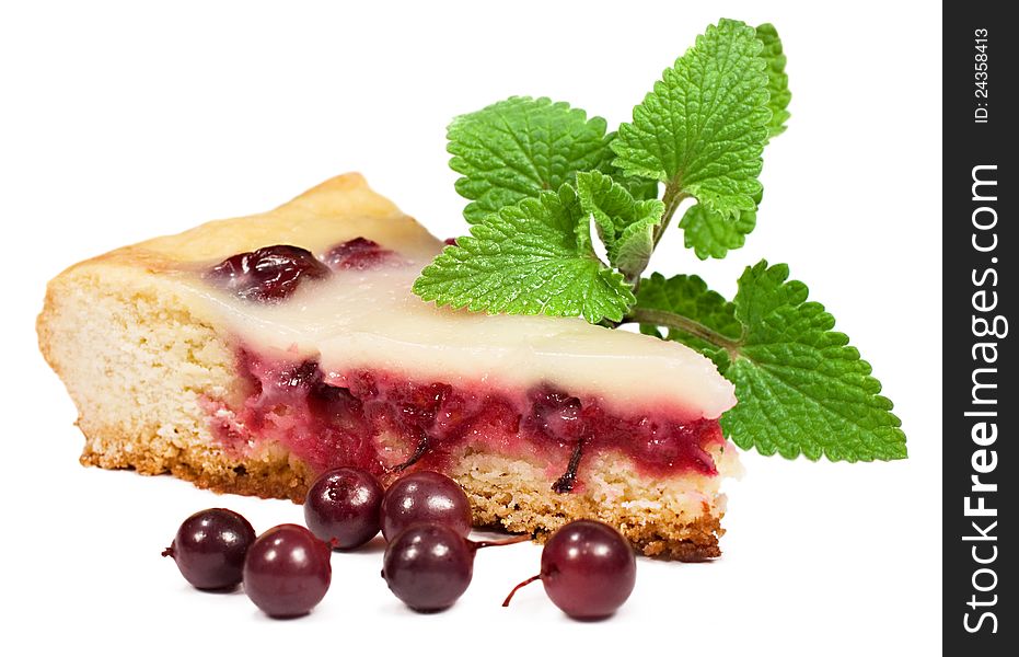 A piece of berry pie with mint leaves on a white background