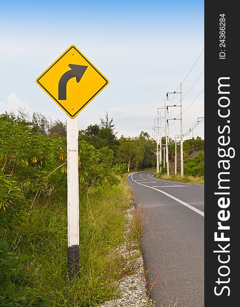 Traffic sign, right  way arrow with road and sky