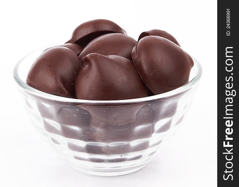 Chocolate candy in bowl on white