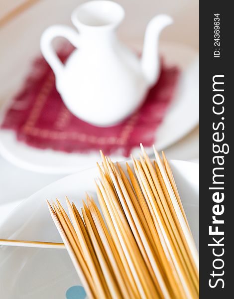 Bamboo skewers in plate on table