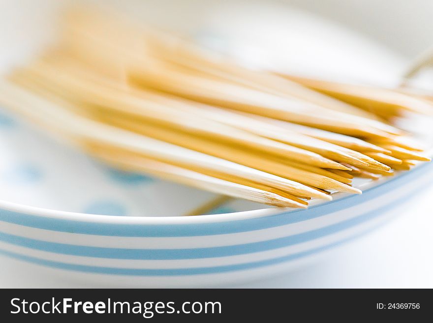 Bamboo skewers in plate on table closeup