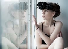 Melancholy - Lovely Girl Sitting By The Window Stock Photo Melancholy - Lovely Girl Sitting By The Window Stock Photo