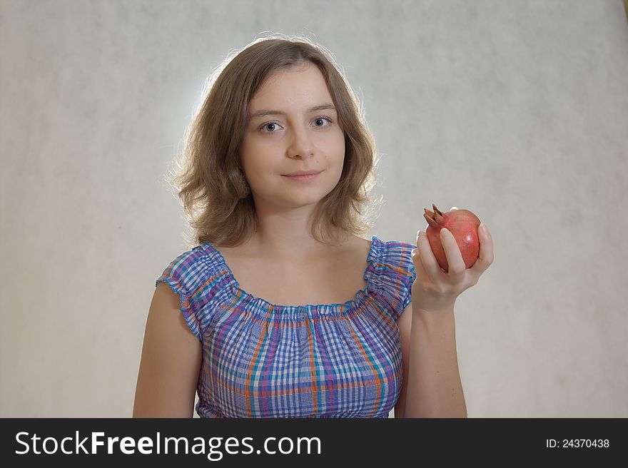 Girl holding pomegranate in the hand. Girl holding pomegranate in the hand