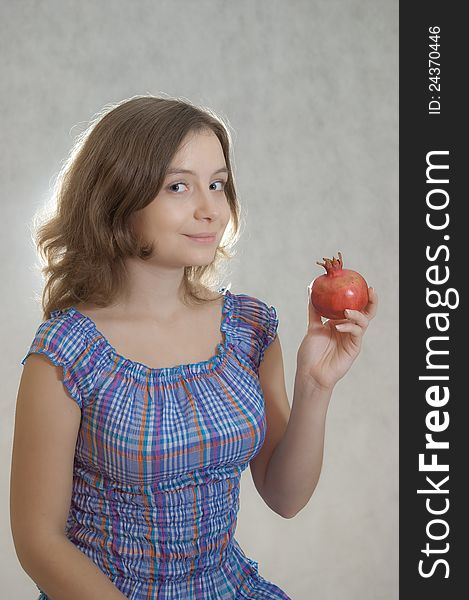 Girl offering pomegranate to spectators. Girl offering pomegranate to spectators