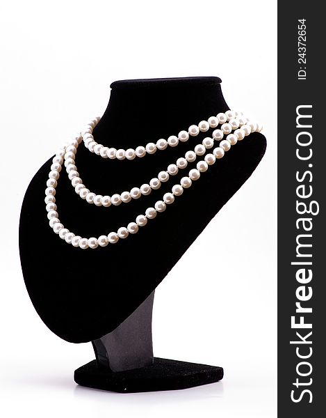 Pearl necklace on black mannequin isolated