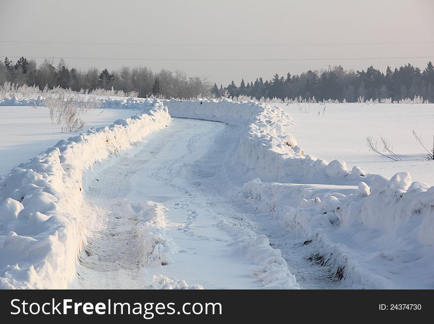 Country road covered with snow. Winter. Frost. Country road covered with snow. Winter. Frost.