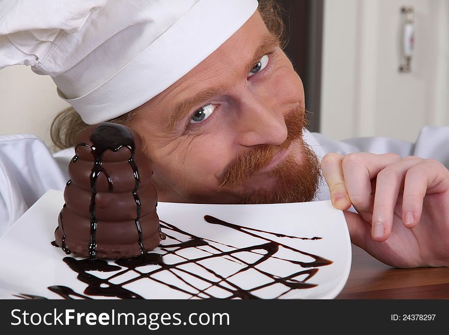 Young chef with piece of cake