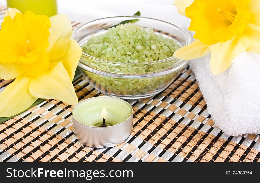 White cotton hand towels yellow white narcissus flower and candle on white background.