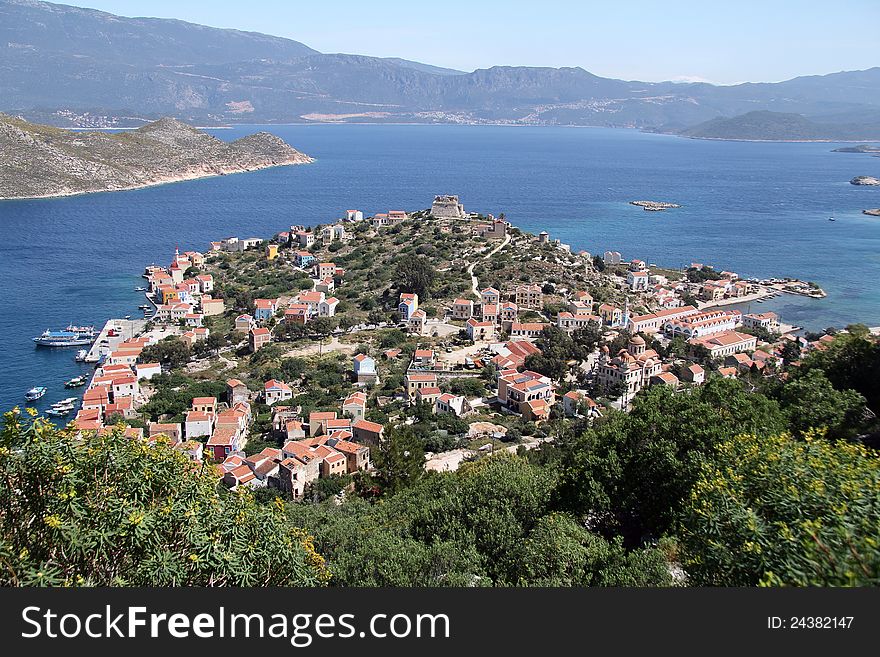 The harbours of the Greek island of Meis, with the Roman castle. Shows the mainland of Turkey in the background. The harbours of the Greek island of Meis, with the Roman castle. Shows the mainland of Turkey in the background