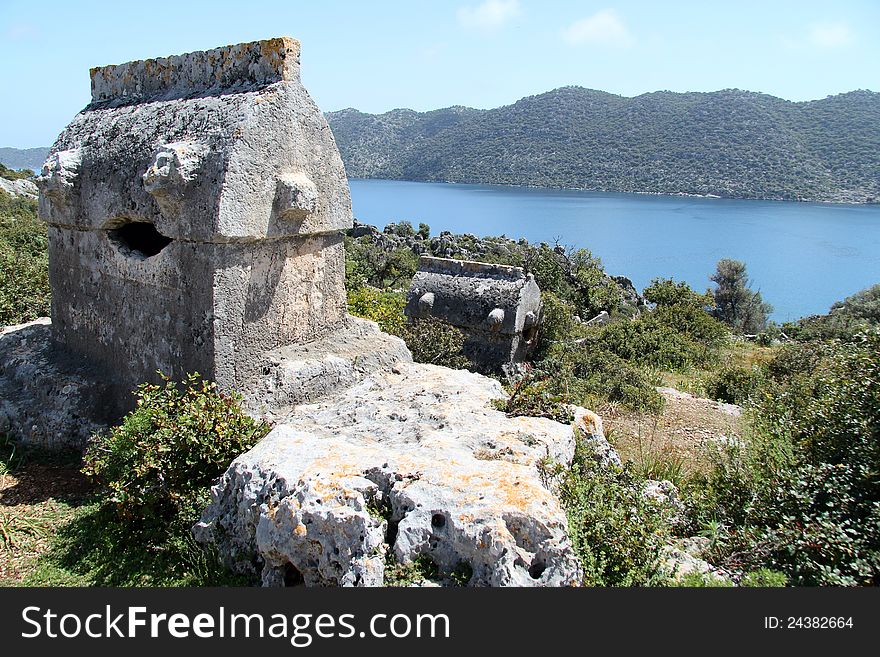 Taken on a walk along the Lycian way to Simena in Turkey. Shows a tomb surroundered by wild flowers on a hillside. Taken on a walk along the Lycian way to Simena in Turkey. Shows a tomb surroundered by wild flowers on a hillside.