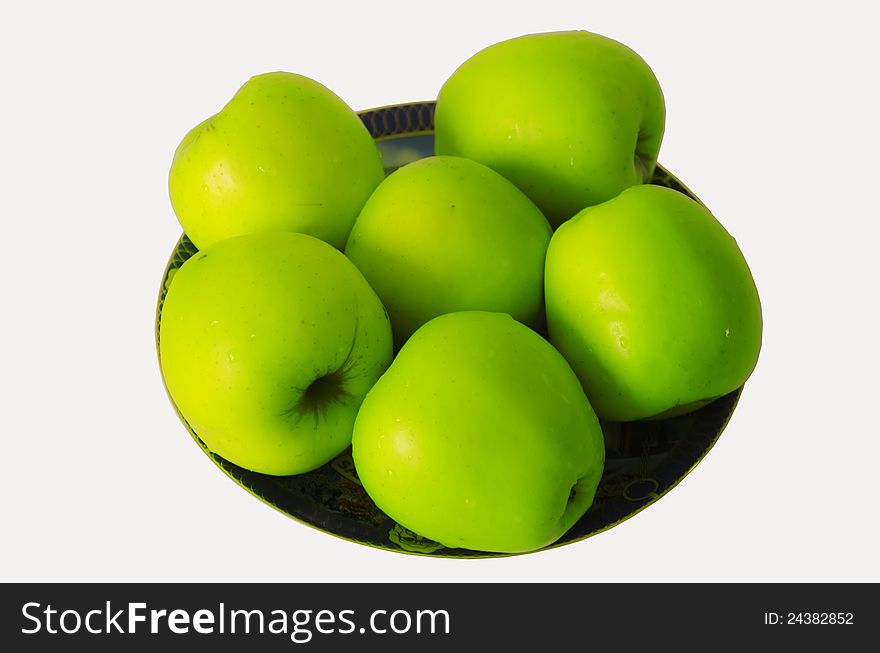 Green apples on a beautiful plate, isolate. Green apples on a beautiful plate, isolate
