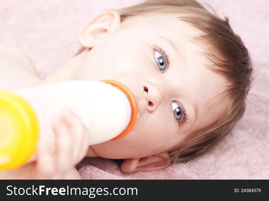 Little baby drinking milk, close up