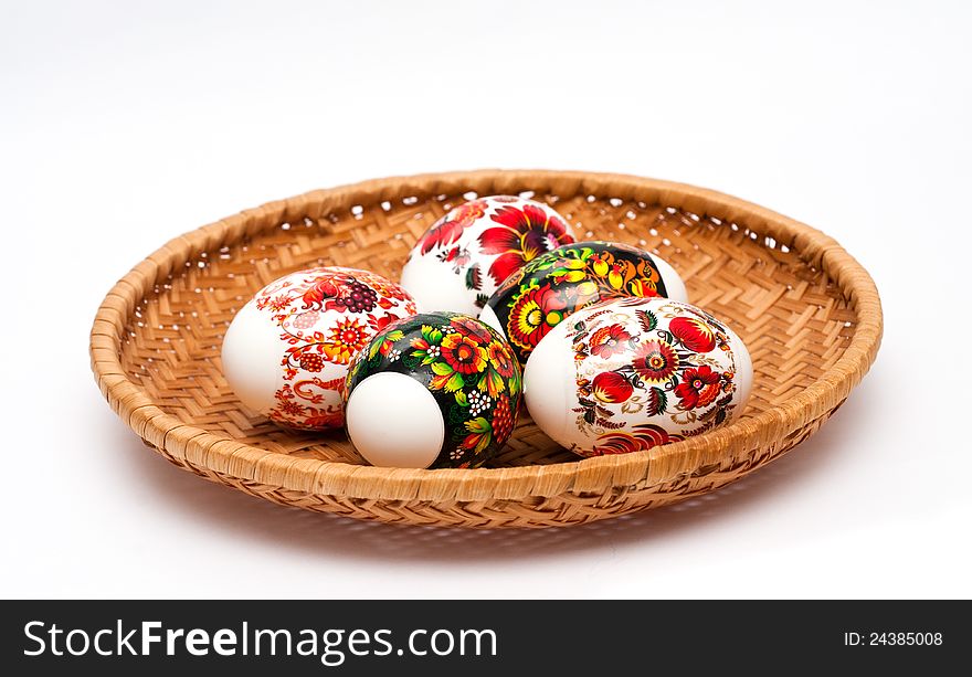 Easter eggs in basket at white