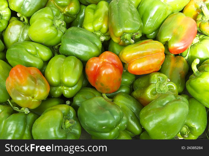 Bunch of Organic Green Bell Pepper.
Some of them have red coloration.