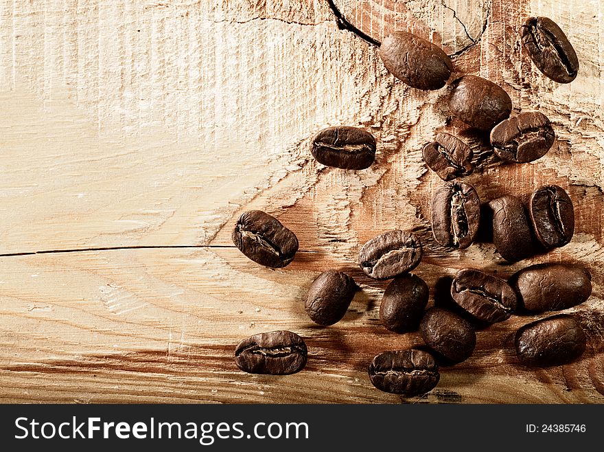 Coffee beans over wooden desk, abstract backgrounds