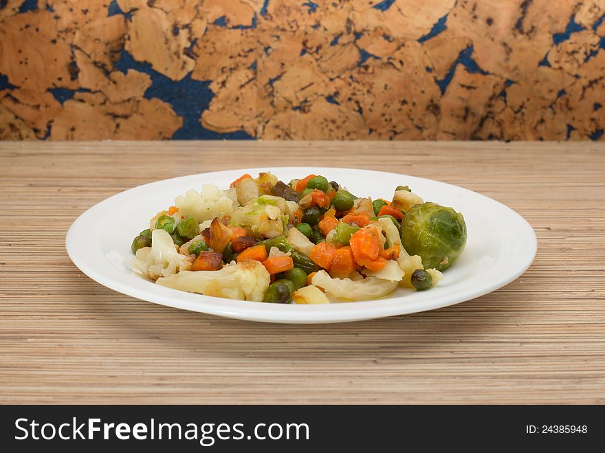 A plate with vegetables on the table