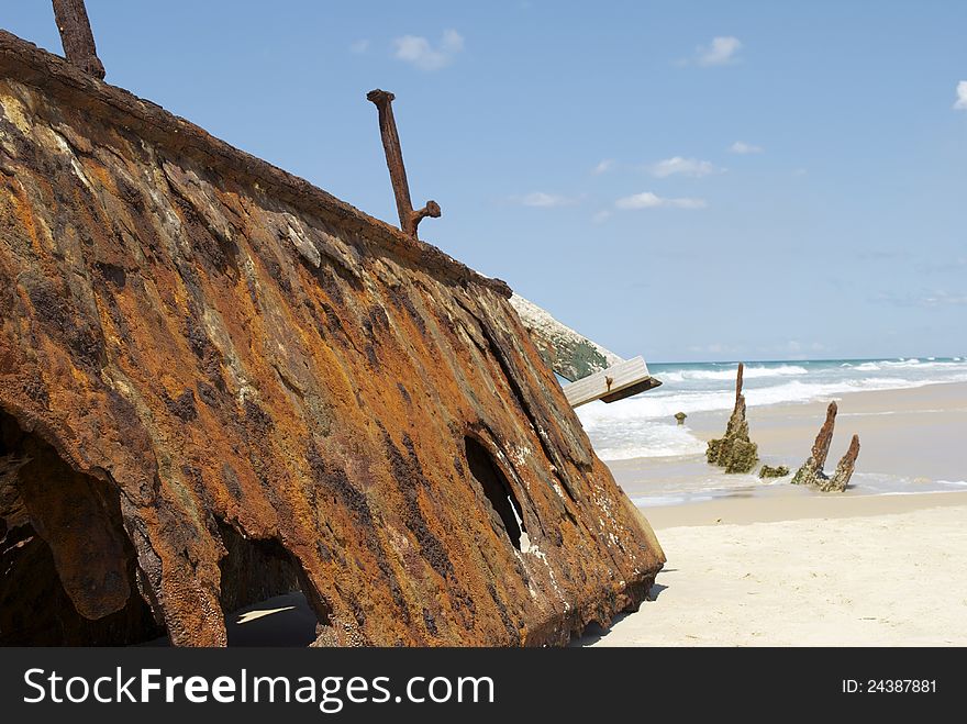 Large rusty shipwreck on a sunny beach. The S.S. Maheno shipwreck on Fraser Island, Queensland, Australia. Large rusty shipwreck on a sunny beach. The S.S. Maheno shipwreck on Fraser Island, Queensland, Australia.