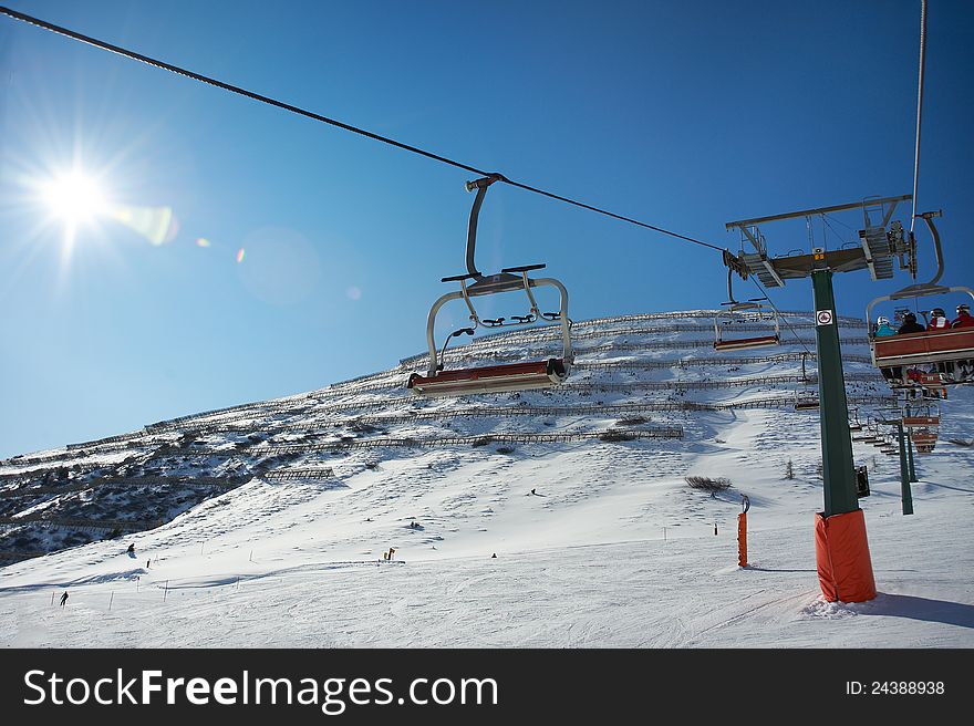 Ski lifts on background of slope with protection from avalanches in sunny day. Ski lifts on background of slope with protection from avalanches in sunny day