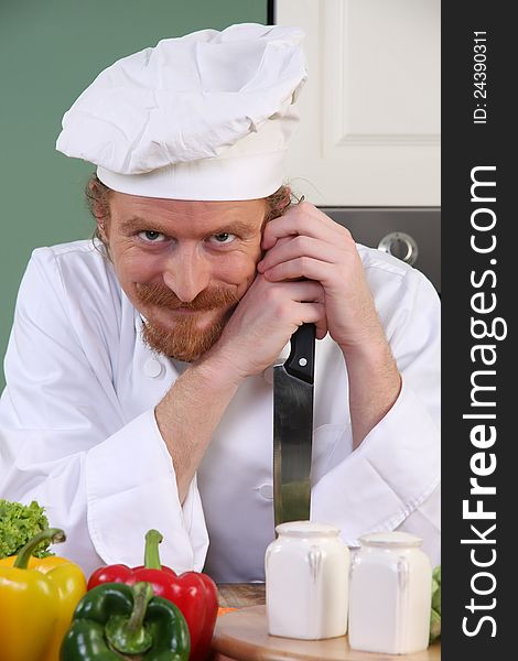 Chef With A Knife In Kitchen