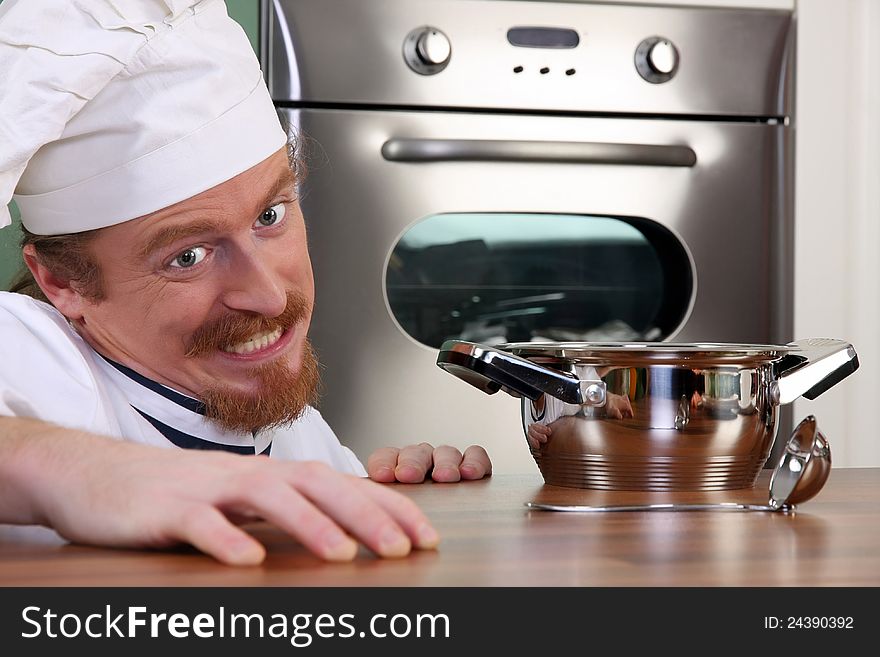 Funny young chef with a pot
