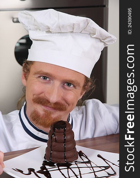 Young chef with piece of cake