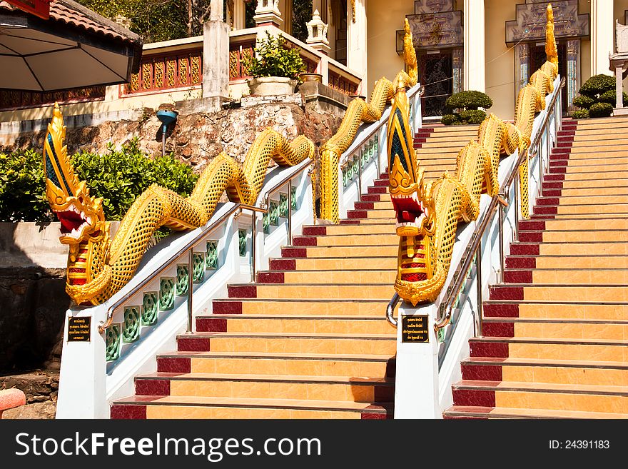 The Serpent statue on the ladder at the entrance to Thai temple.