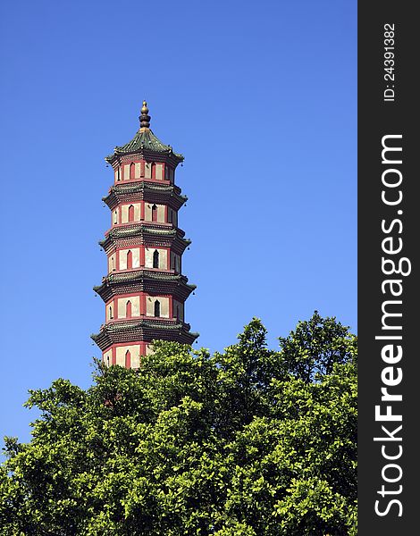 Chinese traditional pagoda against blue sky, with golden gourd on top and copper bells hanging on eaves. Chinese traditional pagoda against blue sky, with golden gourd on top and copper bells hanging on eaves.