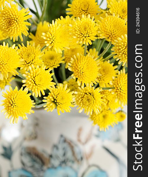Yellow small spring flowers in a vintage vase. Yellow small spring flowers in a vintage vase