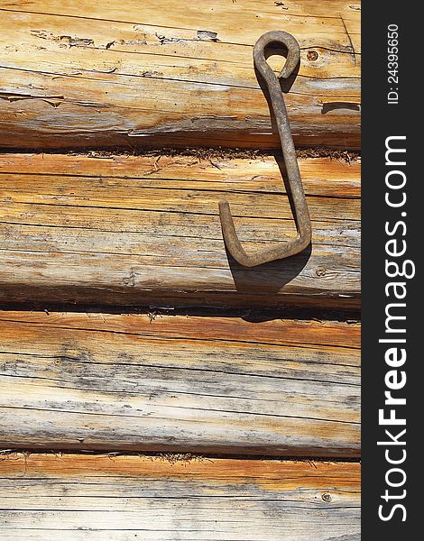 Fragment of wooden frame wall with an iron hook. Texture, background. Fragment of wooden frame wall with an iron hook. Texture, background