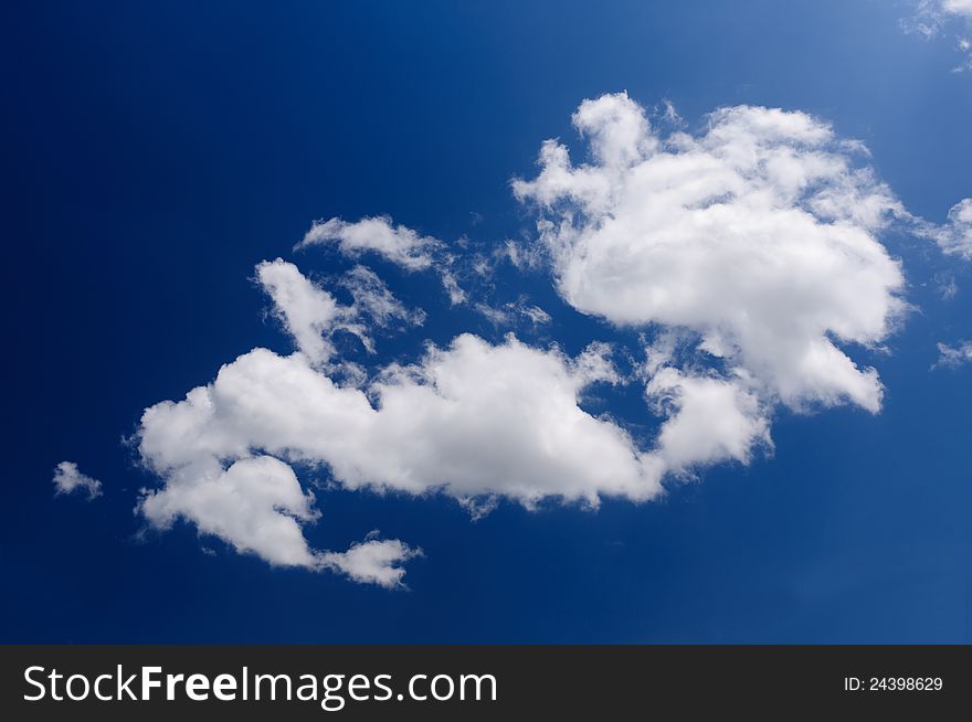 Blue sky background with a tiny clouds