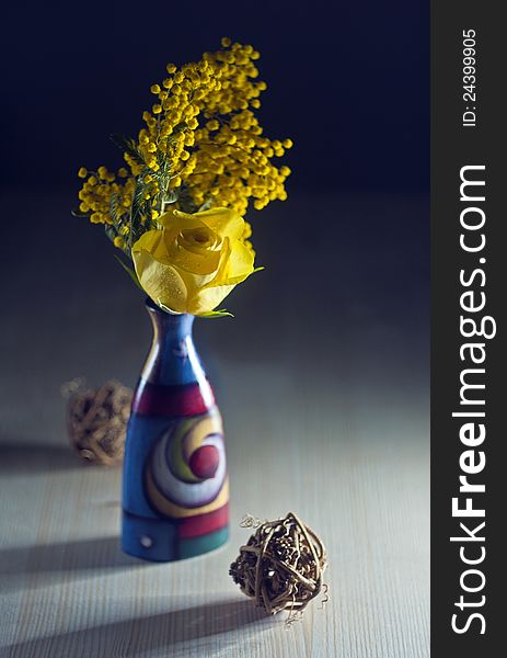 Ranunculus in colore vase with mimosa. Ranunculus in colore vase with mimosa