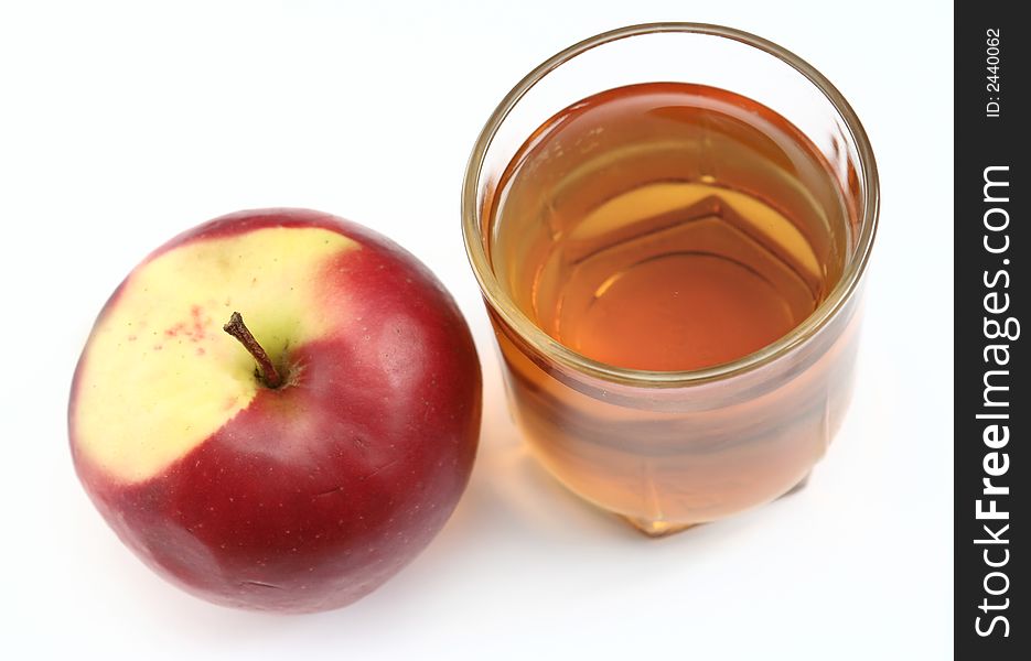 Red apple and glass of juice on a white background